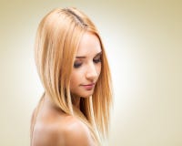 Beautiful blonde woman in profile, looking down on a light background royalty free stock images Beautiful blonde woman in profile, looking down on a light background royalty free stock images