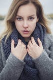 Beautiful blonde young caucasian woman in grey coat and scarf wa royalty free stock photo Beautiful blonde young caucasian woman in grey coat and scarf wa royalty free stock photo