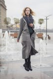 Beautiful blonde young caucasian woman in grey coat and scarf wa royalty free stock photo Beautiful blonde young caucasian woman in grey coat and scarf wa royalty free stock photo