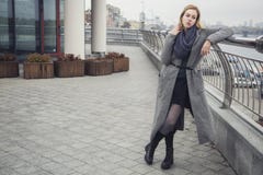 Beautiful blonde young caucasian woman in grey coat and scarf wa royalty free stock images Beautiful blonde young caucasian woman in grey coat and scarf wa royalty free stock images