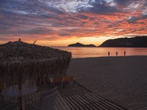 Beautiful blue pink orange clouds after sunset on Agios Georgios Pagon beach at Corfu island, Greece with sun umbrellas stock photography Beautiful blue pink orange clouds after sunset on Agios Georgios Pagon beach at Corfu island, Greece with sun umbrellas stock photography
