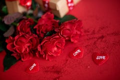 Beautiful bouquet of roses with a gift boxes on a red background stock images Beautiful bouquet of roses with a gift boxes on a red background stock images