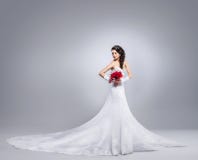 Beautiful bride standing with a flower bouquet royalty free stock image Beautiful bride standing with a flower bouquet royalty free stock image