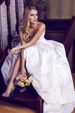 Beautiful Bride With Blond Hair In Elegant Wedding Dress With Bouquet Stock Photo