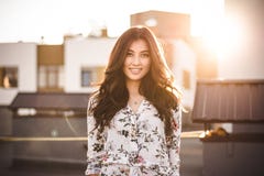 Beautiful brunette on the roof of a house stock photo Beautiful brunette on the roof of a house stock photo