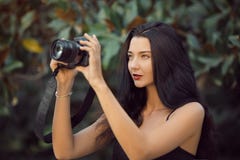 Beautiful Brunette Woman Taking a Picture Outdoor by Digital Camera stock images Beautiful Brunette Woman Taking a Picture Outdoor by Digital Camera stock images
