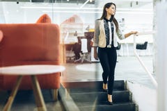 Beautiful businesswoman walking down the stairs Royalty Free Stock Photo Beautiful businesswoman walking down the stairs Royalty Free Stock Photo