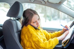 Beautiful businesswoman is working from her car royalty free stock photography Beautiful businesswoman is working from her car royalty free stock photography