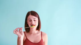Woman licks lollipop