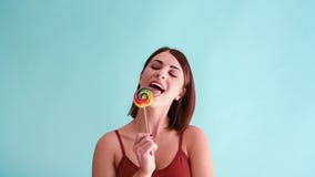 Woman licks lollipop