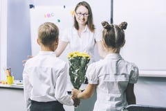 Beautiful children school children with flowers for the teachers