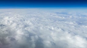 The beautiful cloudscape with clear blue sky. A view from airplane window royalty free stock image The beautiful cloudscape with clear blue sky. A view from airplane window royalty free stock image