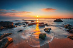 Sunrise on the sea rocks and beautiful clouds royalty free stock photos Sunrise on the sea rocks and beautiful clouds royalty free stock photos