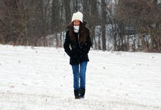 Beautiful confident green eyes teenager walking under snow while snowing stock photo Beautiful confident green eyes teenager walking under snow while snowing stock photo