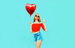 beautiful cool girl sending sweet air kiss with red heart shaped balloon on colorful blue royalty free stock image beautiful cool girl sending sweet air kiss with red heart shaped balloon on colorful blue royalty free stock image