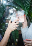 Beautiful couple holding dry ice cocktails at the party. Purple cocktail drink with ice vapor at the club, celebration stock photography Beautiful couple holding dry ice cocktails at the party. Purple cocktail drink with ice vapor at the club, celebration stock photography