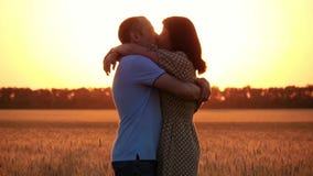 A beautiful couple in love in a wheat field at sunset. The woman runs to the man kisses and embraces him. Happy family stock video A beautiful couple in love in a wheat field at sunset. The woman runs to the man kisses and embraces him. Happy family stock video