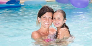 Daughter with pretty single mother in home private pool stock images Daughter with pretty single mother in home private pool stock images