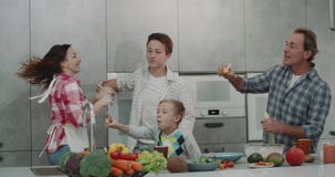 Beautiful family in the kitchen have a great time dacing and making bubbles , adult parents and two boy 9 years old and stock footage Beautiful family in the kitchen have a great time dacing and making bubbles , adult parents and two boy 9 years old and stock footage