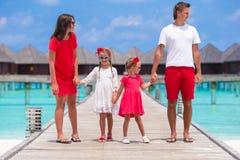 Beautiful family in red having fun on wooden jetty royalty free stock photos Beautiful family in red having fun on wooden jetty royalty free stock photos
