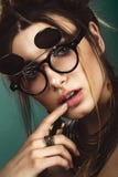 Beautiful fashion woman with creative make-up, hairstyle wearing glasses and jewelry. beauty face. royalty free stock image Beautiful fashion woman with creative make-up, hairstyle wearing glasses and jewelry. beauty face. royalty free stock image