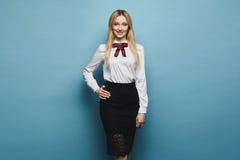 Beautiful and fashionable blonde model girl with perfect body in stylish blouse and black lace skirt, smiling and posing at studio stock image Beautiful and fashionable blonde model girl with perfect body in stylish blouse and black lace skirt, smiling and posing at studio stock image