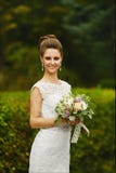 Beautiful and fashionable brunette model girl with bright make-up and with wedding hairstyle, young stylish bride in stock image Beautiful and fashionable brunette model girl with bright make-up and with wedding hairstyle, young stylish bride in stock image