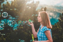 Beautiful female blowing bubbles at sunset stock photography Beautiful female blowing bubbles at sunset stock photography