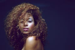 Beautiful female fashion model with curly hair