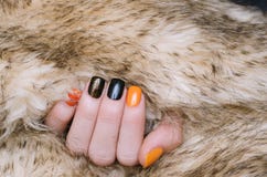 Beautiful female hand with orange and black nail art stock image Beautiful female hand with orange and black nail art stock image