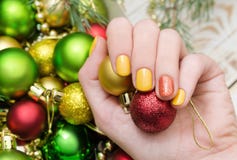 Beautiful female hand with yellow nail design. Christmas manicure. stock photos Beautiful female hand with yellow nail design. Christmas manicure. stock photos