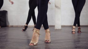 Beautiful female legs in ballroom shoes dancing bachata basic steps. stock footage Beautiful female legs in ballroom shoes dancing bachata basic steps. stock footage