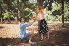 https://thumbs.dreamstime.com/t/beautiful-flowers-were-presented-to-girl-holiday-young-guy-gives-flowers-to-his-girlfriend-woods-woman-100159386.jpg