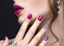 Beautiful girl with a bright evening make-up and pink manicure with rhinestones. Nail design. Beauty face. Stock Photo Beautiful girl with a bright evening make-up and pink manicure with rhinestones. Nail design. Beauty face. Stock Photo