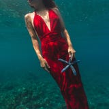 Beautiful girl caucasian in red dress under water stock photography Beautiful girl caucasian in red dress under water stock photography
