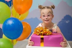 Beautiful girl with down syndrome with a birthday present