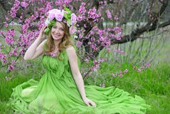 Beautiful girl in the flowered garden peach Stock Images Beautiful girl in the flowered garden peach Stock Images