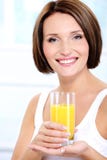 Beautiful Girl Holding Glass Of Fresh Orange Juice Stock Image