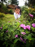 Beautiful girl looking happy sorrounded by flower stock photos Beautiful girl looking happy sorrounded by flower stock photos
