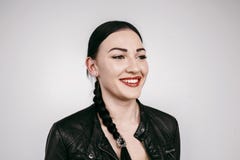Beautiful girl with pigtail smiling in black jacket isolated royalty free stock photo Beautiful girl with pigtail smiling in black jacket isolated royalty free stock photo