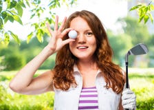 Beautiful girl with red hair and a golf ball royalty free stock image Beautiful girl with red hair and a golf ball royalty free stock image