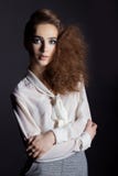 Beautiful girl in shirt and trousers in business style in the Studio on a black background, Im a hair and make-up stock photos Beautiful girl in shirt and trousers in business style in the Studio on a black background, Im a hair and make-up stock photos