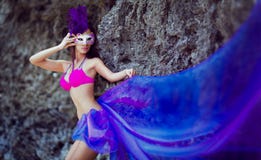 Beautiful girl in a Venetian mask wearing a long purple cloth royalty free stock photo Beautiful girl in a Venetian mask wearing a long purple cloth royalty free stock photo