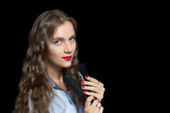 Beautiful girl holding black combs stock photos Beautiful girl holding black combs stock photos