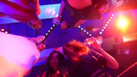 Beautiful girls dancing at a party with glasses in their hands - a disco at a birthday party stock footage Beautiful girls dancing at a party with glasses in their hands - a disco at a birthday party stock footage