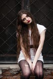 Beautiful goth girl. Horror woman. Scary Girl and Halloween theme: portrait of a crazy girl with a bloody face in the studio. Ghos royalty free stock images Beautiful goth girl. Horror woman. Scary Girl and Halloween theme: portrait of a crazy girl with a bloody face in the studio. Ghos royalty free stock images