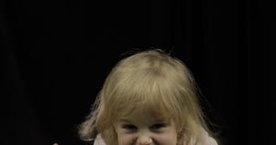 Child with dirty face from melted chocolate and whipped cream smiling stock video footage Child with dirty face from melted chocolate and whipped cream smiling stock video footage