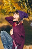 A beautiful happy smiling young woman in the autumn park Royalty Free Stock Image A beautiful happy smiling young woman in the autumn park Royalty Free Stock Image
