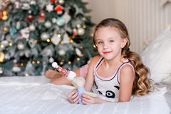 Beautiful little girl sitting near the Christmas tree. stock image Beautiful little girl sitting near the Christmas tree. stock image
