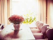 Beautiful living room with Chrysanthemums flowers bunch on dinner table at window background. Stock Photography Beautiful living room with Chrysanthemums flowers bunch on dinner table at window background. Stock Photography